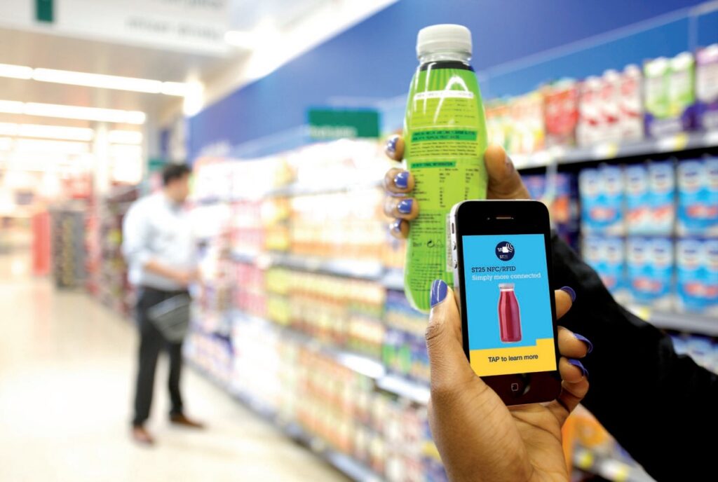 Customer scanning a beverage bottle with smartphone using NFC technology in a retail store