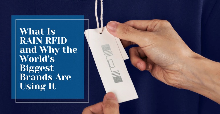 Hand holding a clothing label with a visible RAIN RFID antenna tag attached to a garment, illustrating how major retail brands use RFID technology for smart inventory tracking.